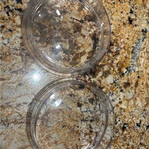 Two glass small pet dishes.